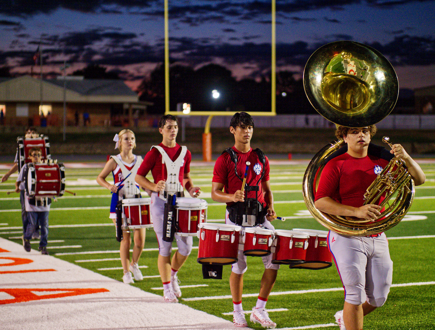 Alba-Golden football players and a cheerleader fill out the percussion section during halftime. [find more football photos]